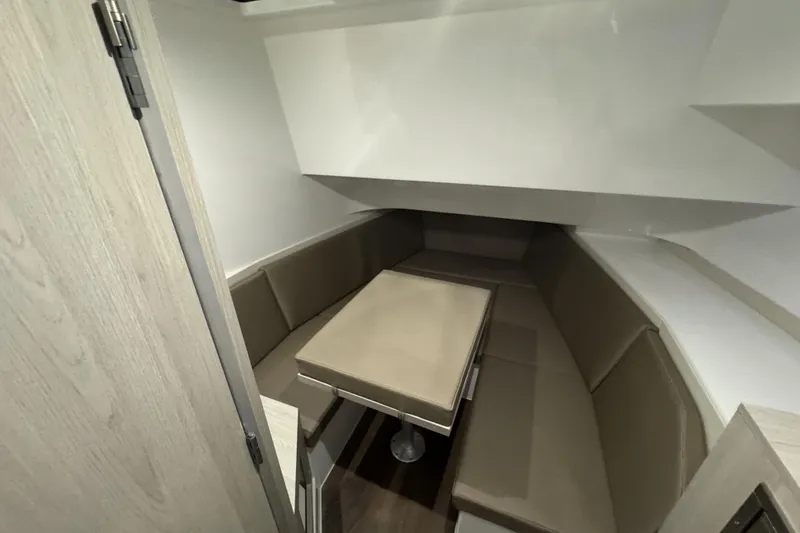 Slide: The Image of 2026 Cruisers Yachts 38 VTR interior with beige seating and table. - 12