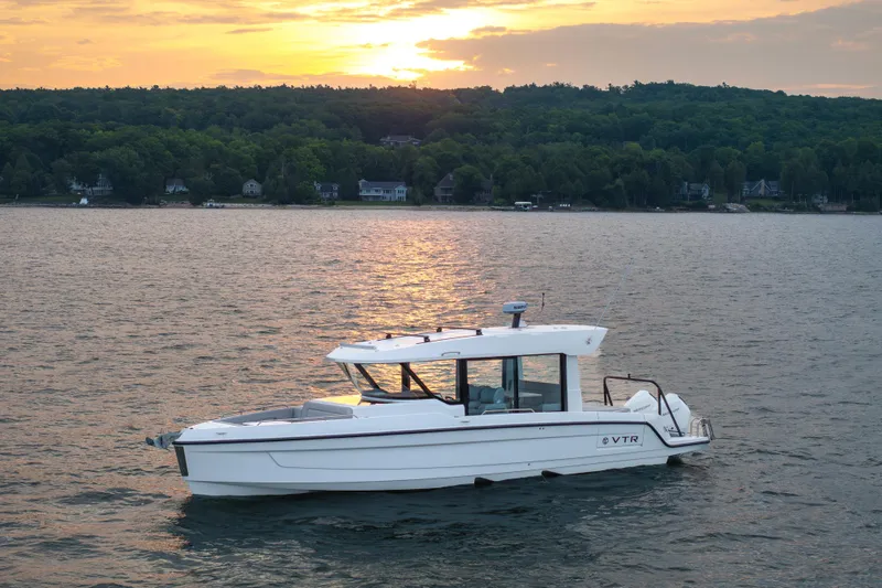 Slide: The Image of 2026 Cruisers Yachts 38 VTR on a serene lake at sunset. - 19