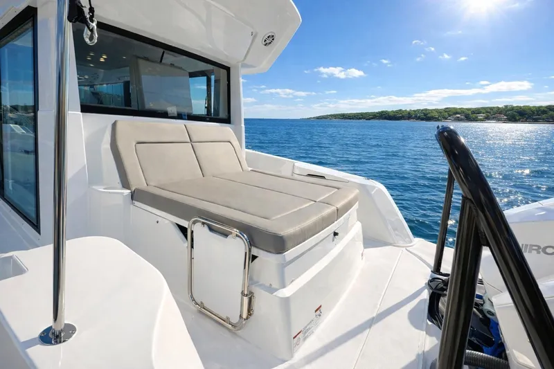 Slide: The Image of 2026 Cruisers Yachts 38 VTR luxury deck with sunbed, overlooking serene ocean view. - 3