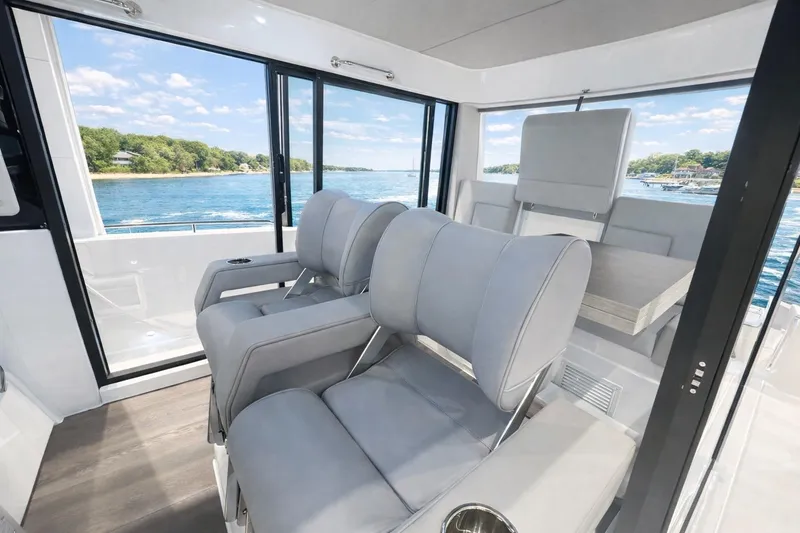 Slide: The Image of Luxurious interior of 2026 Cruisers Yachts 38 VTR with plush seating and scenic water view. - 7