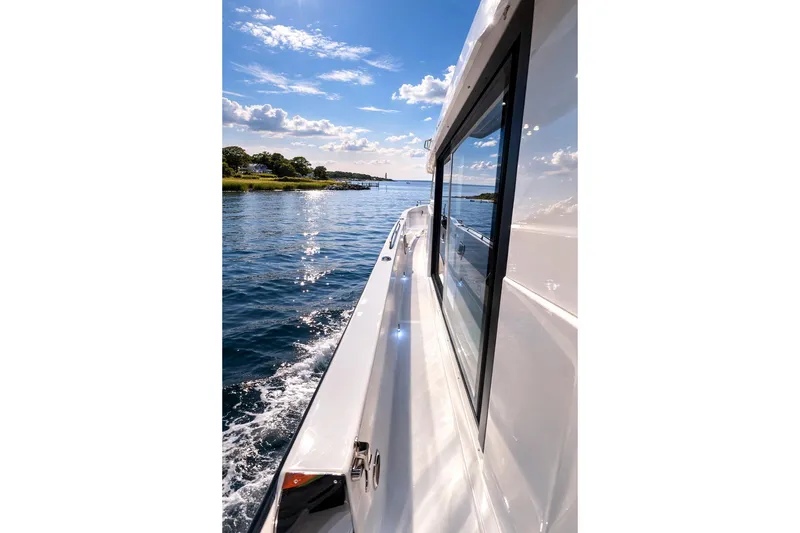 Slide: The Image of 2026 Cruisers Yachts 38 VTR cruising on a sunny day, reflecting on calm waters. - 14