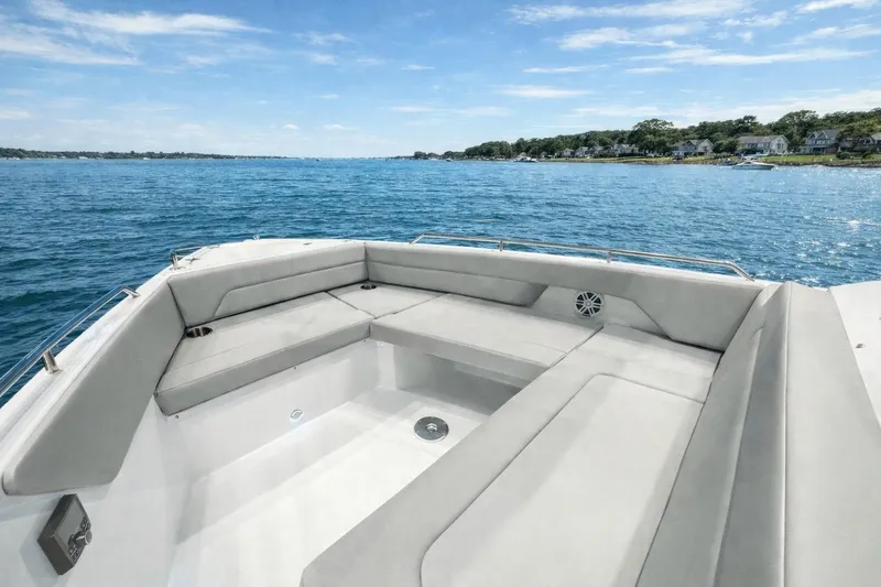 Slide: The Image of 2026 Cruisers Yachts 38 VTR boat with spacious seating, overlooking serene blue waters. - 16