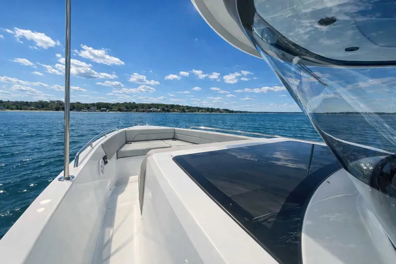 Slide: The Image of 2026 Cruisers Yachts 38 VTR on serene blue waters under a clear sky. - 15