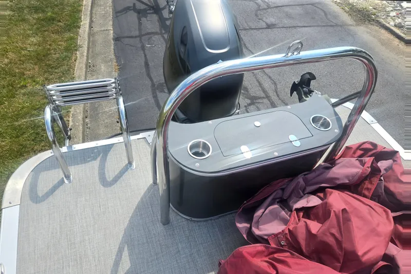 Slide: The Image of 2024 Avalon LSZ Cruise Bench boat deck with ladder and storage compartment. - 16