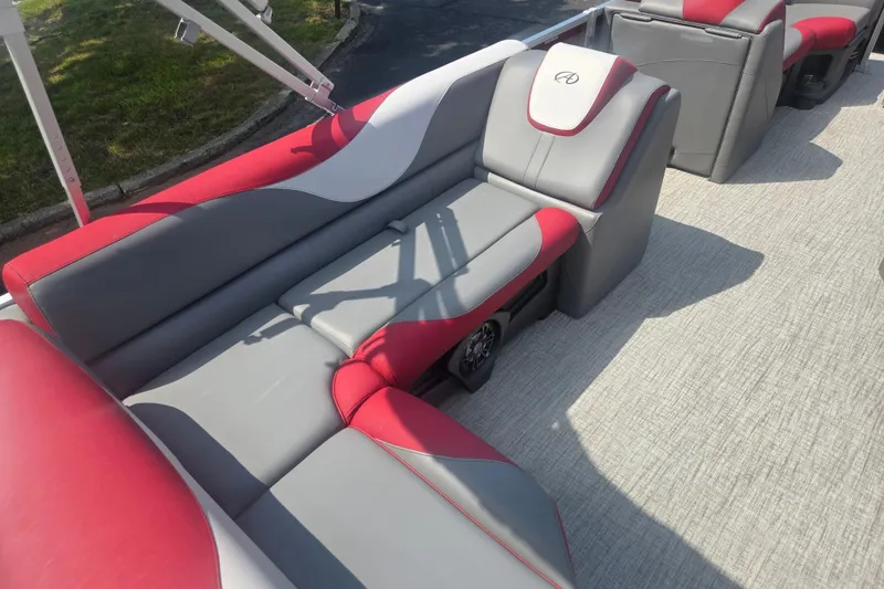 Slide: The Image of 2024 Avalon LSZ Cruise Bench with red and gray seating on a boat deck. - 19