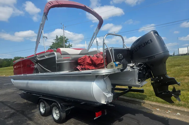 Slide: The Image of 2024 Avalon LSZ Cruise Bench pontoon boat with Suzuki outboard motor on trailer. - 3