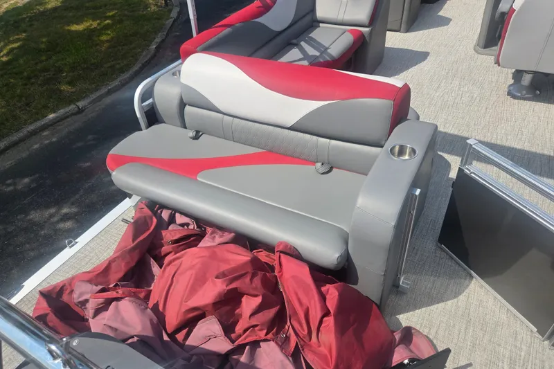Slide: The Image of 2024 Avalon LSZ Cruise Bench with red and gray upholstery on a boat deck. - 17