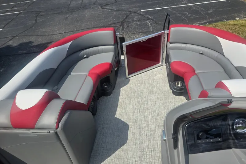 Slide: The Image of 2024 Avalon LSZ Cruise Bench interior with red and gray seating, open gate, and dashboard view. - 22
