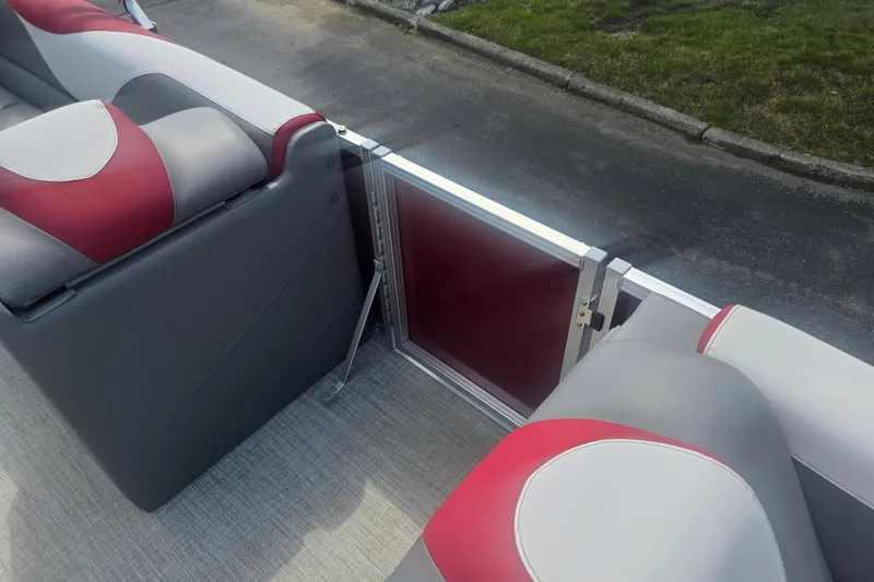 Slide: The Image of 2024 Avalon LSZ Cruise Bench with red and gray seating on a boat deck. - 12