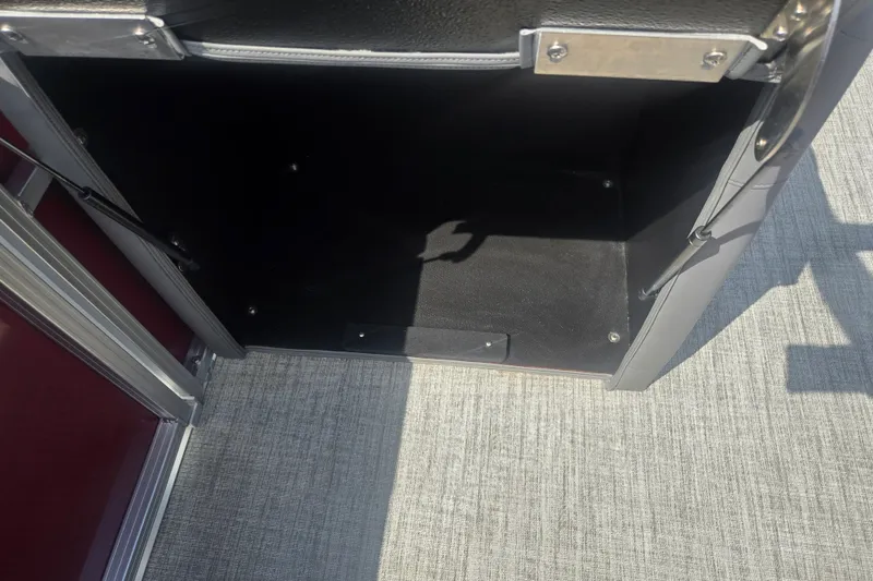 Slide: The Image of Open storage compartment in 2024 Avalon LSZ Cruise Bench boat. - 23