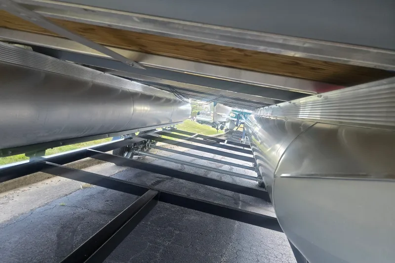 Slide: The Image of Underneath view of 2024 Avalon LSZ Cruise Bench pontoon boat on trailer. - 7