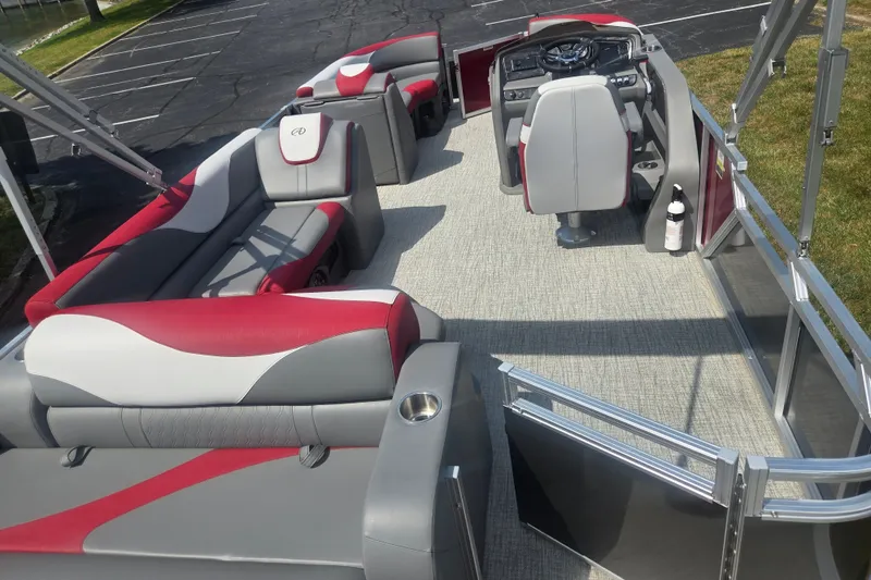 Slide: The Image of 2024 Avalon LSZ Cruise Bench pontoon boat interior with red and gray seating. - 18