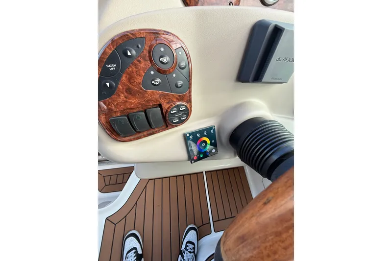 Slide: The Image of 2007 Sea Ray 280 Cuddy Cabin dashboard with wood accents and control panel. - 6