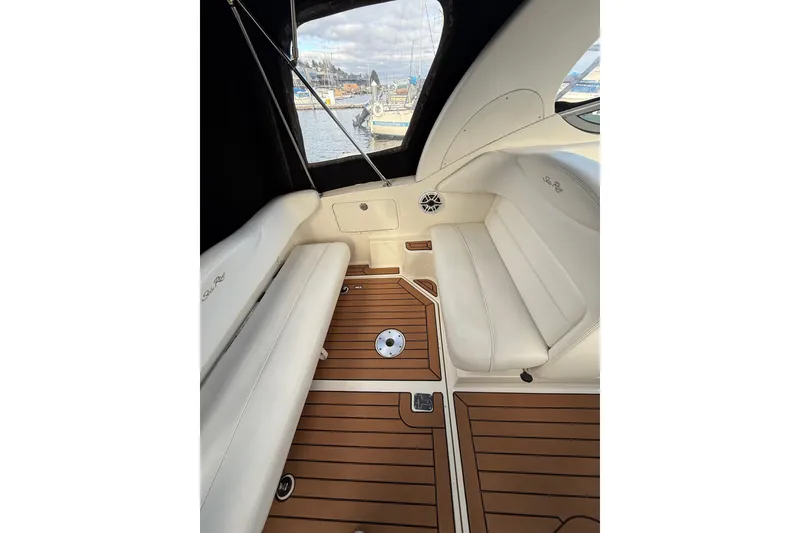 Slide: The Image of 2007 Sea Ray 280 Cuddy Cabin interior with white seating and wood flooring. - 8