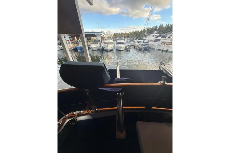 Slide: The Image of 1983 Ocean Alexander 43 Flush Aft Deck yacht view at marina with boats and cloudy sky. - 17