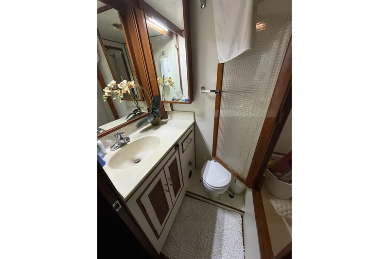 Slide: The Image of Bathroom interior of 1983 Ocean Alexander 43 Flush Aft Deck yacht, featuring sink and shower. - 12
