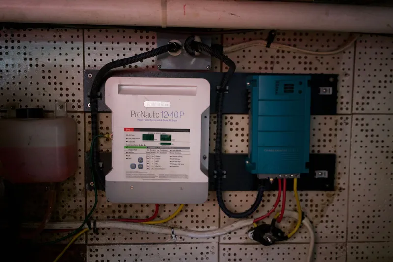 Slide: The Image of Electrical system setup on a 1978 DeFever 39 boat, featuring ProNautic 12-40P charger. - 21