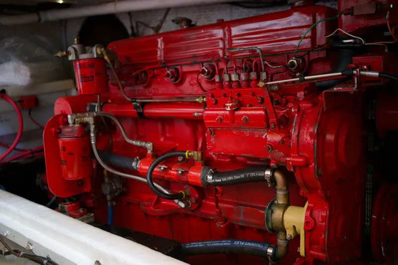 Slide: The Image of Engine of a 1978 DeFever 39 boat, featuring vibrant red components and intricate piping. - 18