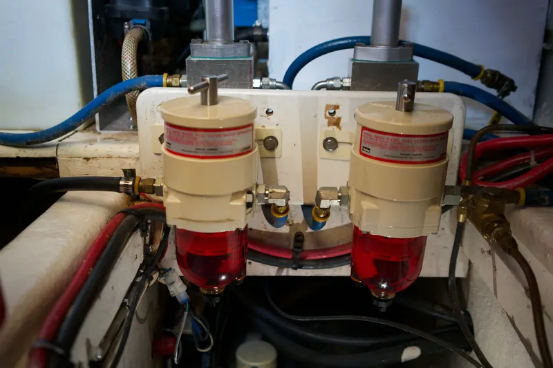 Slide: The Image of Engine room of 1978 DeFever 39 with dual fuel filters and hoses. - 22