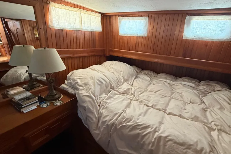 Slide: The Image of Cozy cabin interior of 1978 DeFever 39 yacht with wooden paneling and comfortable bedding. - 7