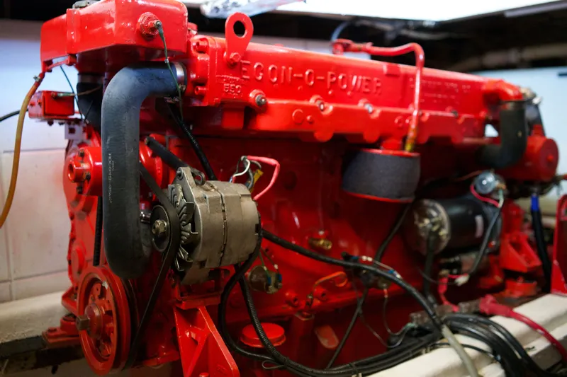 Slide: The Image of Red engine of a 1978 DeFever 39 boat, showcasing mechanical components. - 17