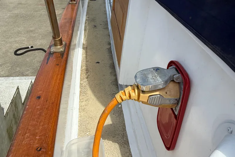 Slide: The Image of Power connection on a 1978 DeFever 39 boat with wooden railing. - 13