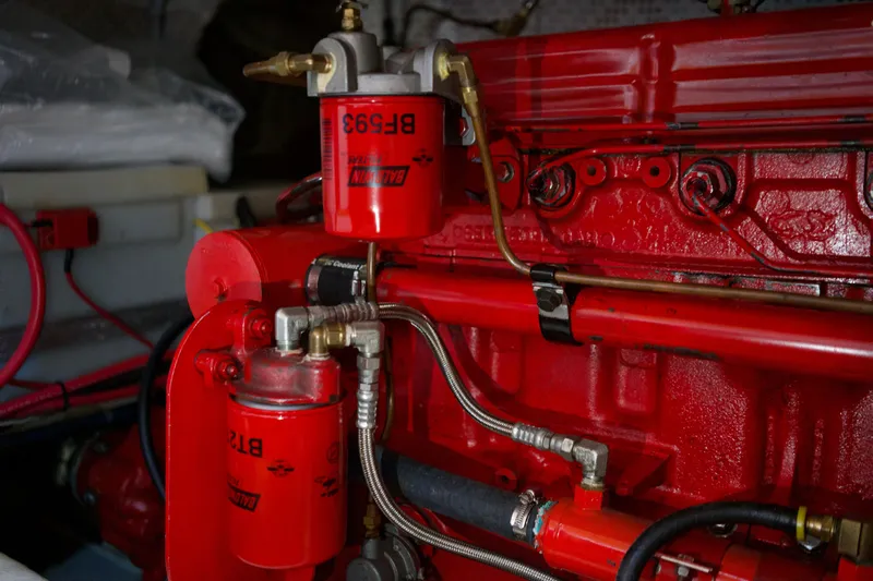 Slide: The Image of Engine compartment of a 1978 DeFever 39 boat with red fuel filters and hoses. - 19