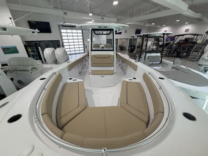 Slide: The Image of The image shows the interior of a 2027 Sportsman Heritage 261 Center Console boat. It features beige upholstery and modern amenities. - 9