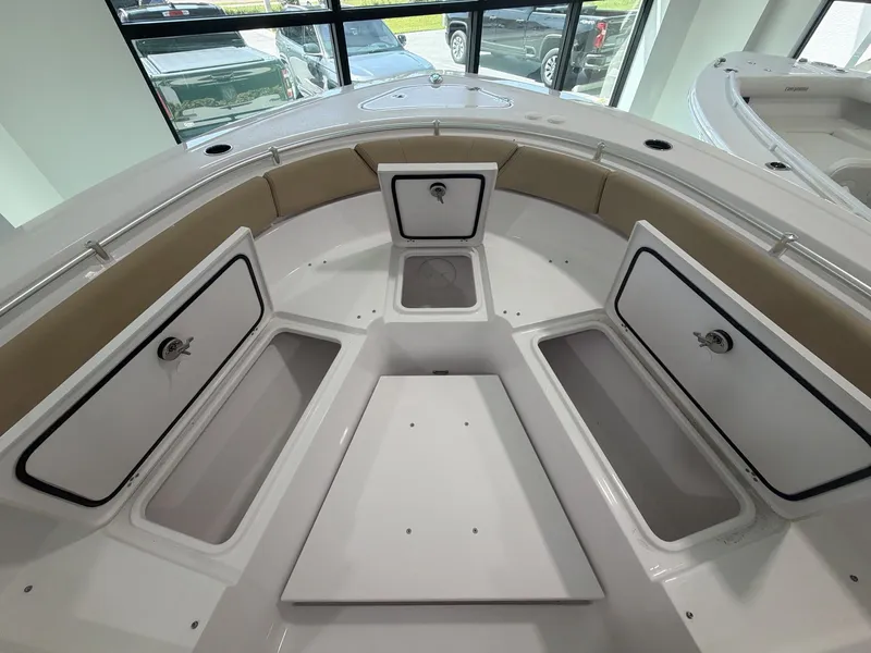 Slide: The Image of The image shows the bow of a Sportsman Heritage 261 Center Console boat with multiple storage compartments. - 12