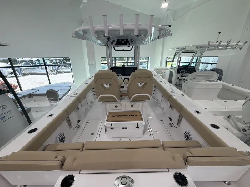Slide: The Image of The image shows the interior of a Sportsman Heritage 261 Center Console boat. It features beige upholstery. - 10