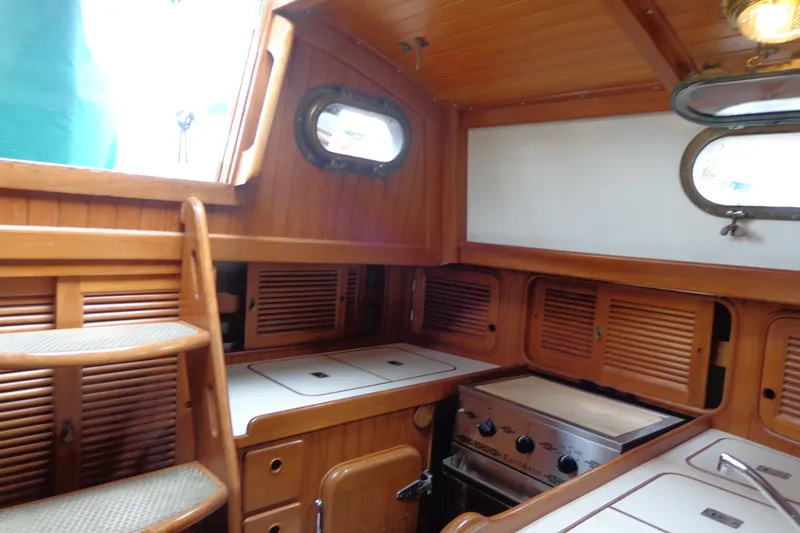 Slide: The Image of 1988 Ta Shing Tashiba Cutter interior with wooden cabinetry and compact kitchen area. - 26