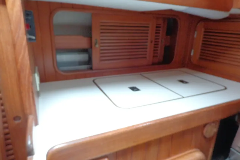 Slide: The Image of 1988 Ta Shing Tashiba Cutter interior with wooden cabinetry and white countertop. - 23