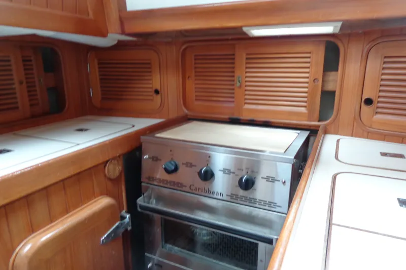 Slide: The Image of 1988 Ta Shing Tashiba Cutter yacht kitchen with wooden cabinets and stainless steel stove. - 20