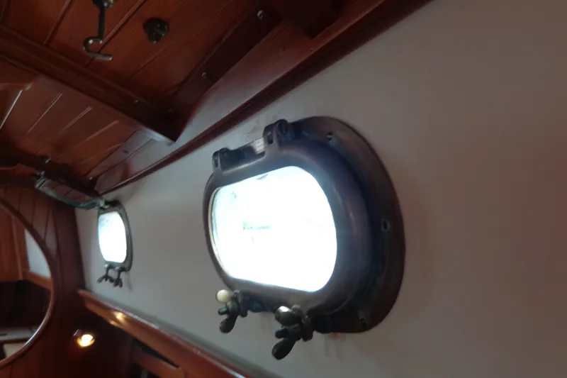 Slide: The Image of Interior view of 1988 Ta Shing Tashiba Cutter, featuring classic portholes and wooden paneling. - 43