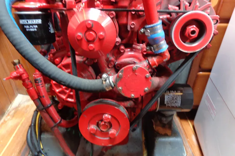 Slide: The Image of Red engine of a 1988 Ta Shing Tashiba Cutter sailboat, featuring visible fuel filter and hoses. - 40