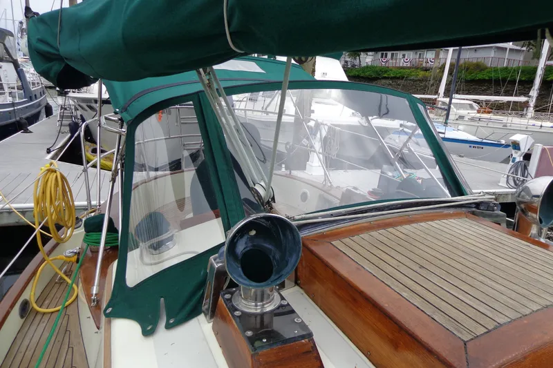 Slide: The Image of 1988 Ta Shing Tashiba Cutter sailboat with green canopy docked at marina. - 14