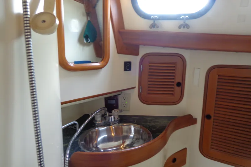 Slide: The Image of Interior of 1988 Ta Shing Tashiba Cutter, featuring a compact bathroom with sink and wooden accents. - 33