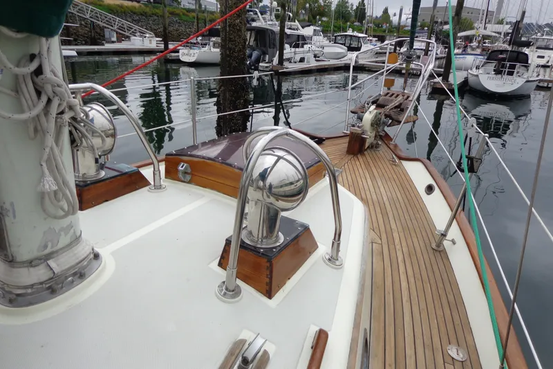 Slide: The Image of 1988 Ta Shing Tashiba Cutter sailboat deck with polished wood and metal fittings in marina. - 13