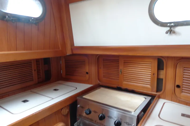 Slide: The Image of 1988 Ta Shing Tashiba Cutter yacht kitchen with wooden cabinets and stove. - 22