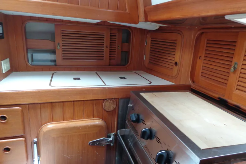 Slide: The Image of 1988 Ta Shing Tashiba Cutter yacht interior with wooden cabinetry and stove. - 46