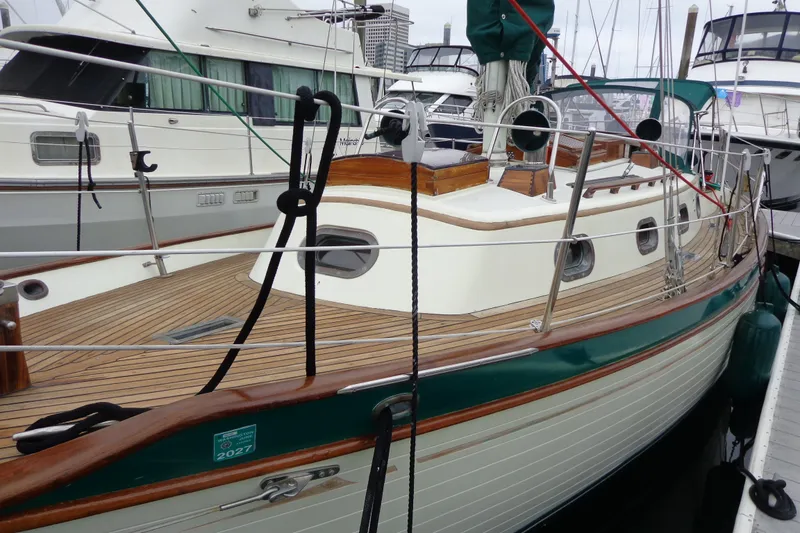 Slide: The Image of 1988 Ta Shing Tashiba Cutter sailboat docked, featuring wooden deck and classic design. - 52
