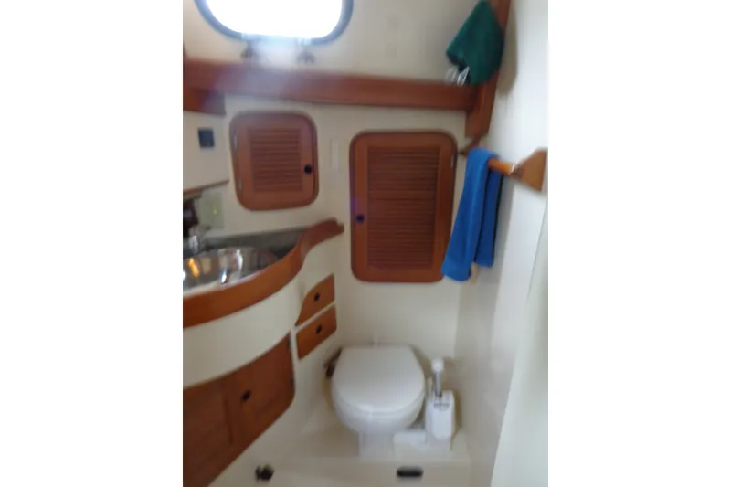 Slide: The Image of 1988 Ta Shing Tashiba Cutter yacht bathroom with wooden cabinets and stainless steel sink. - 31
