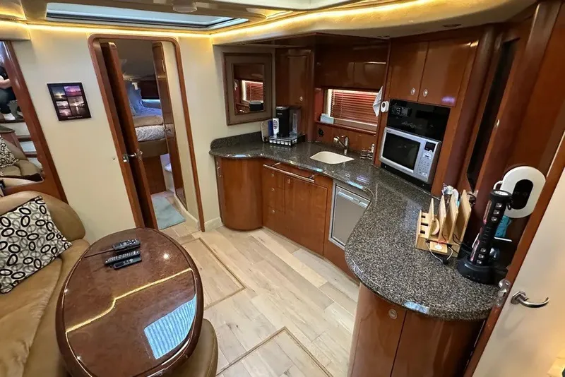Slide: The Image of Luxurious 2006 Sea Ray 44 Sundancer yacht interior with modern kitchen and cozy seating area. - 20