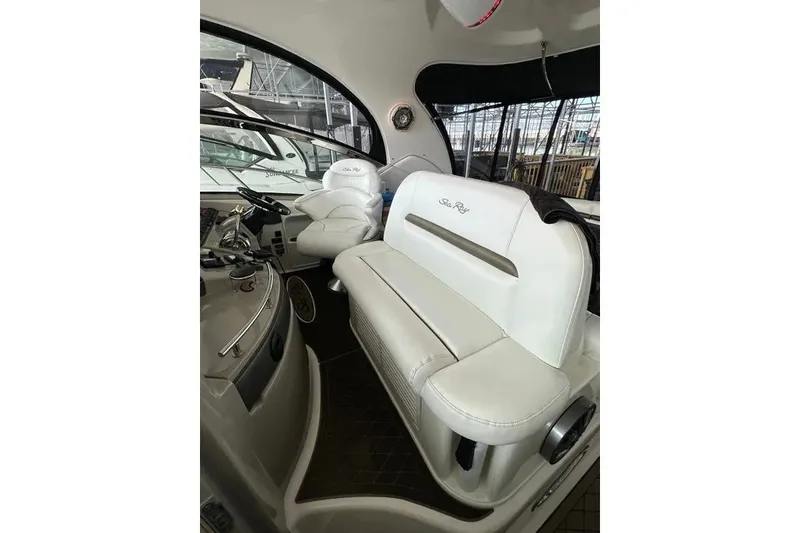 Slide: The Image of 2006 Sea Ray 44 Sundancer cockpit with white leather seating and control panel. - 31