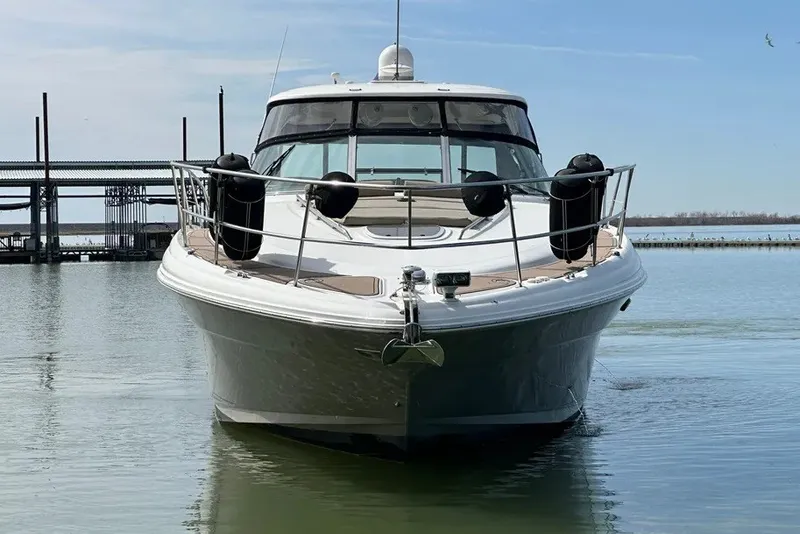 Slide: The Image of 2006 Sea Ray 44 Sundancer yacht docked on calm water, front view. - 10