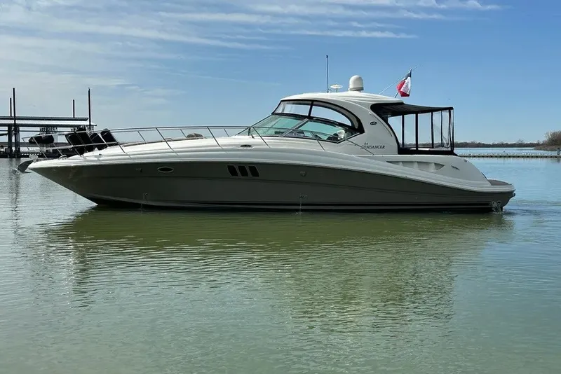Slide: The Image of 2006 Sea Ray 44 Sundancer yacht on calm water under clear sky. - 4