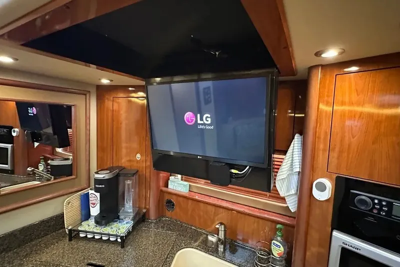 Slide: The Image of Interior of 2006 Sea Ray 44 Sundancer with LG TV and kitchen amenities. - 24
