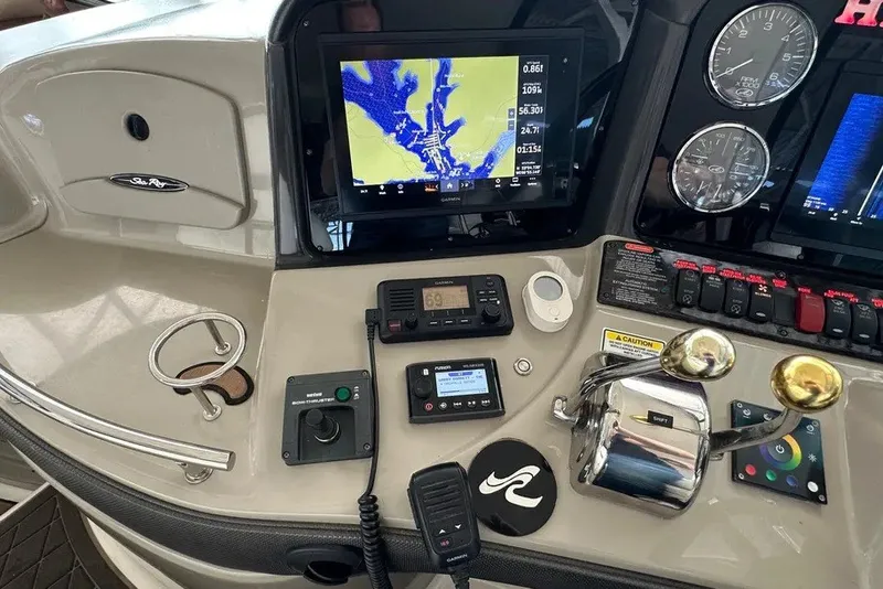 Slide: The Image of Control panel of a 2006 Sea Ray 44 Sundancer with navigation and communication equipment. - 32