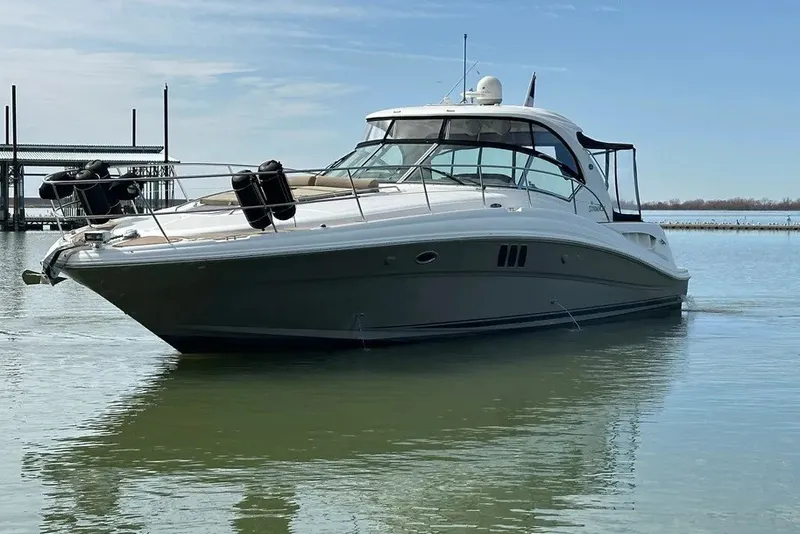 Slide: The Image of 2006 Sea Ray 44 Sundancer yacht on calm water under clear sky. - 7