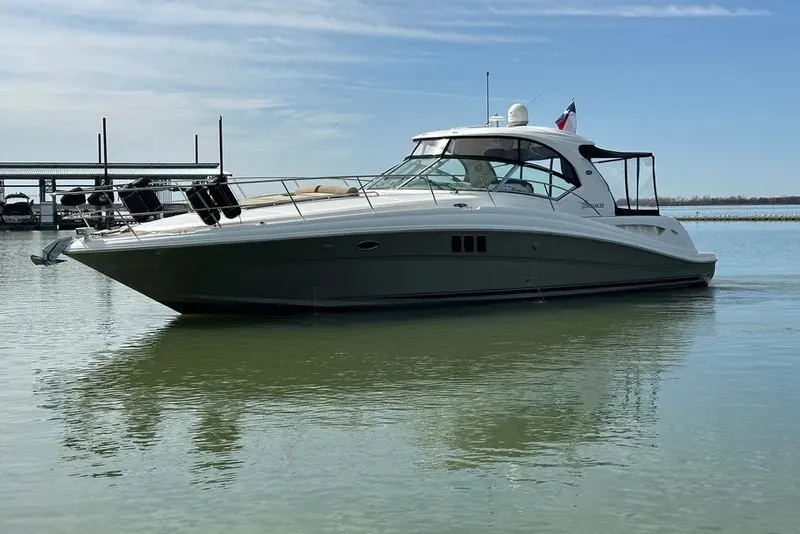 Slide: The Image of 2006 Sea Ray 44 Sundancer yacht on calm water under a clear sky. - 6